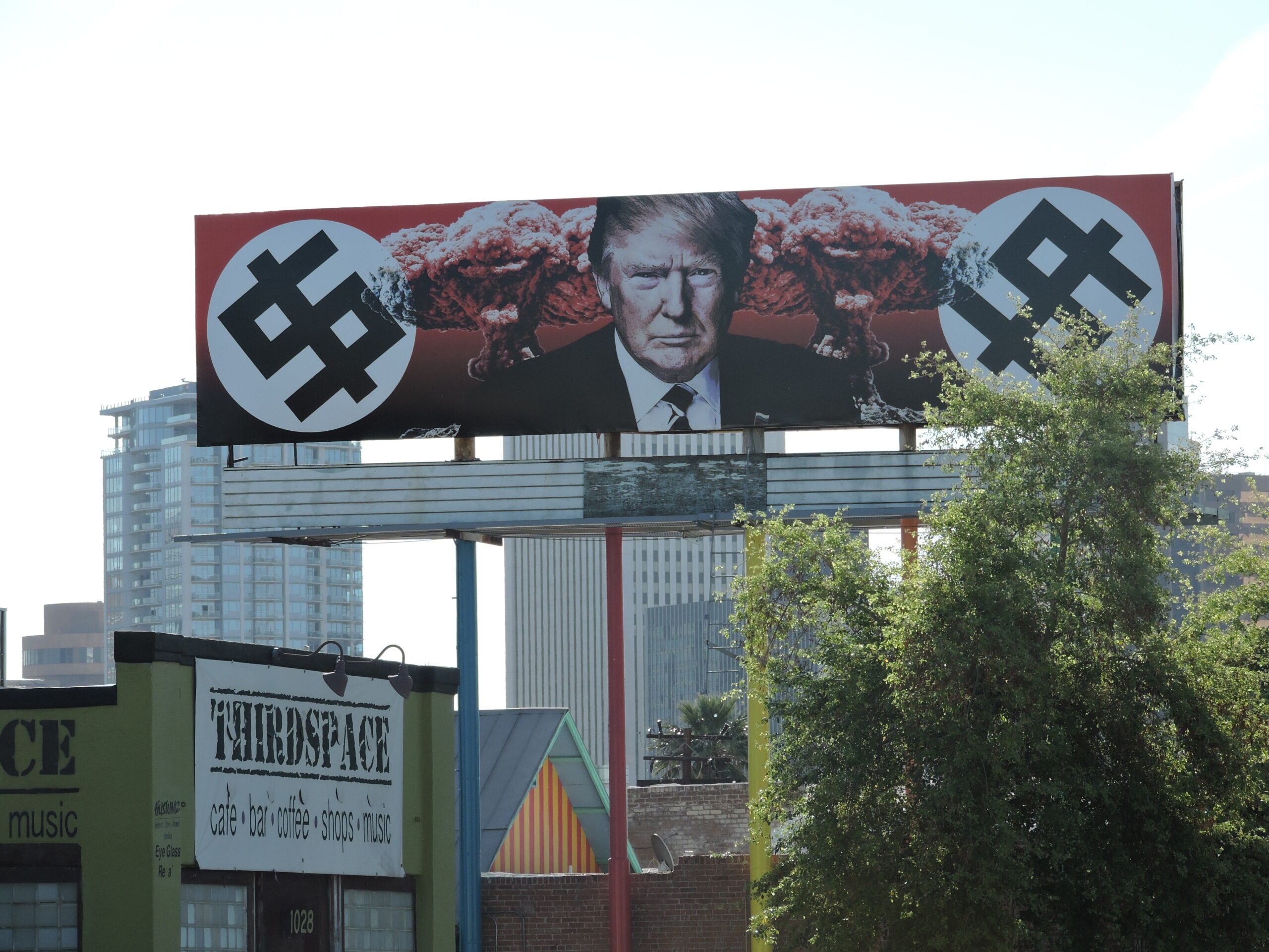 Trump Depicted with Swastika-Like Dollar Signs and Mushroom Clouds on Phoenix Billboard